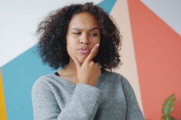 thoughtful woman contemplating misconceptions about health insurance