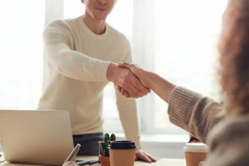 licensed insurance agent shaking hands with client