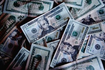 photograph of a pile of dollar bills as healthcare costs rise